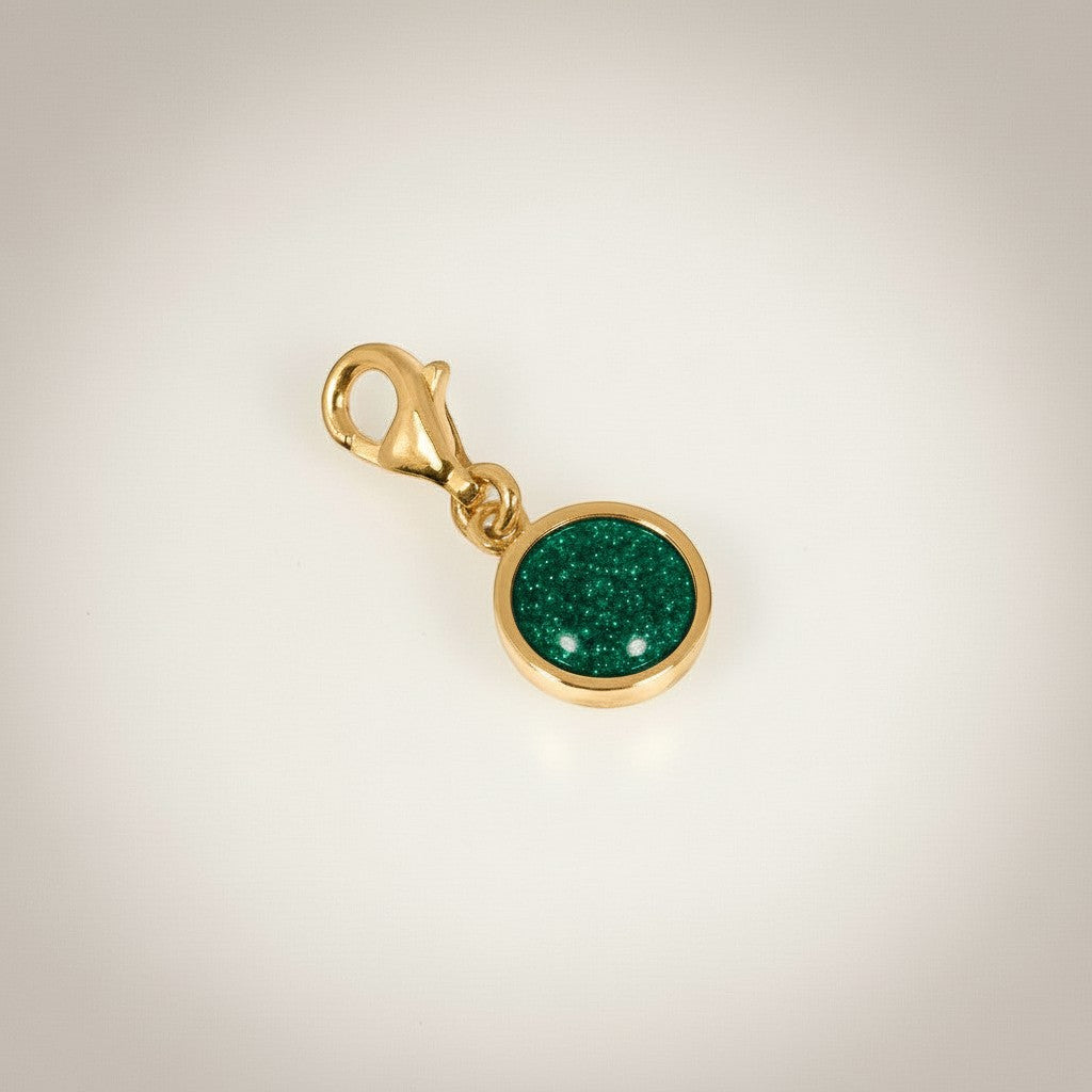 Ashes In Jewellery silver-tone round charm with green glitter cabochon and lobster clasp.