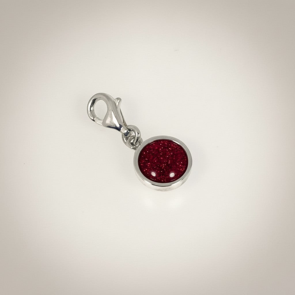 Ashes In Jewellery silver-tone round charm with blue glitter cremation ash cabochon and lobster clasp.