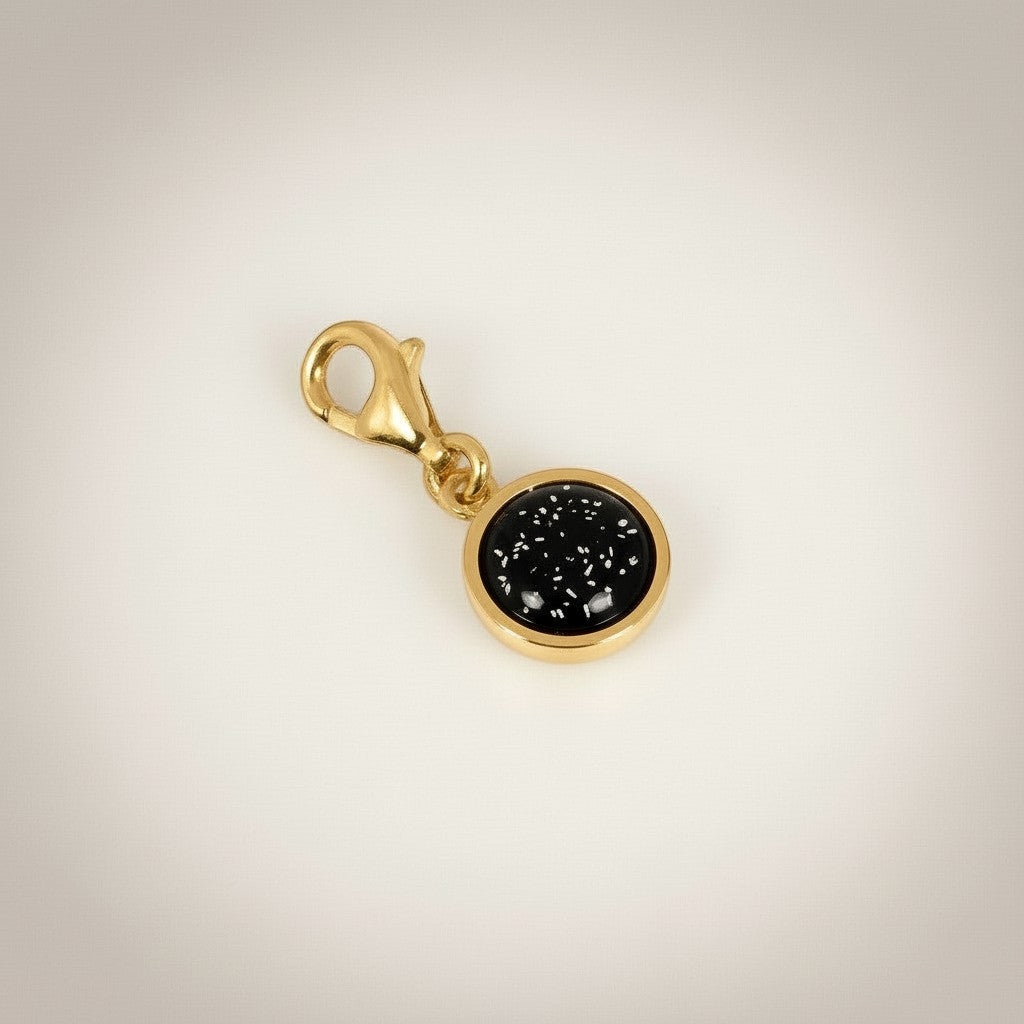 Ashes In Jewellery gold-tone round charm with black cabochon and lobster clasp.