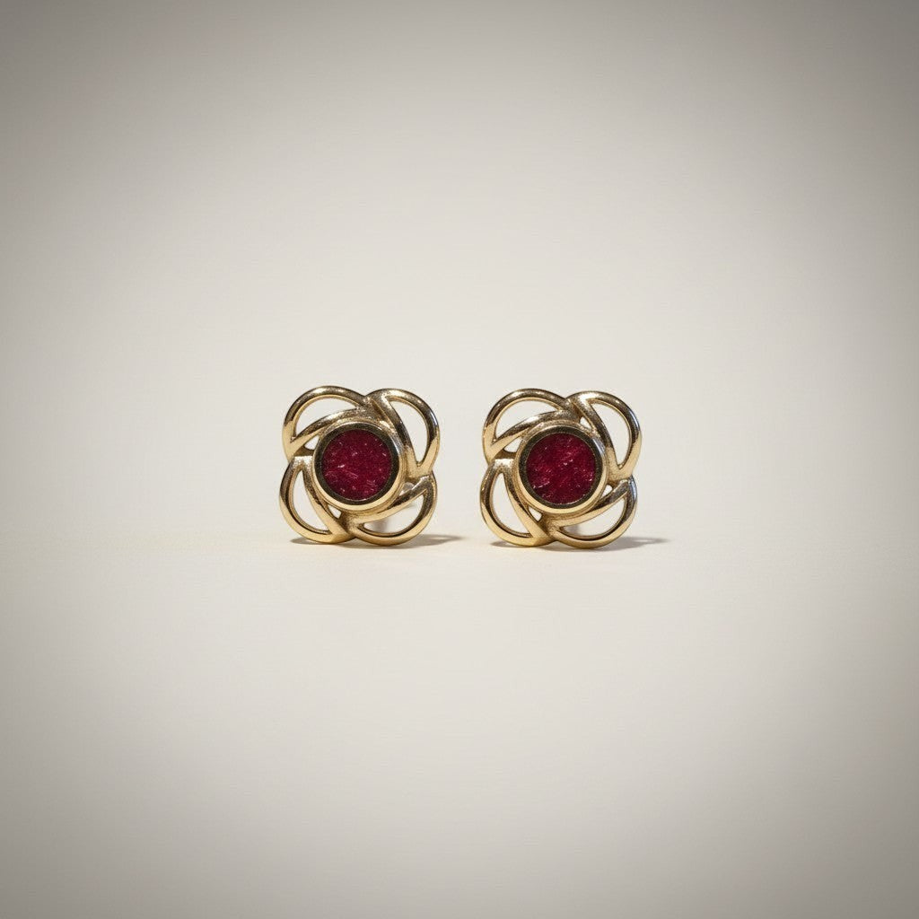 Ashes In Jewellery gold-tone stud earrings with deep red stone and swirling flower design. Secure screw-back.