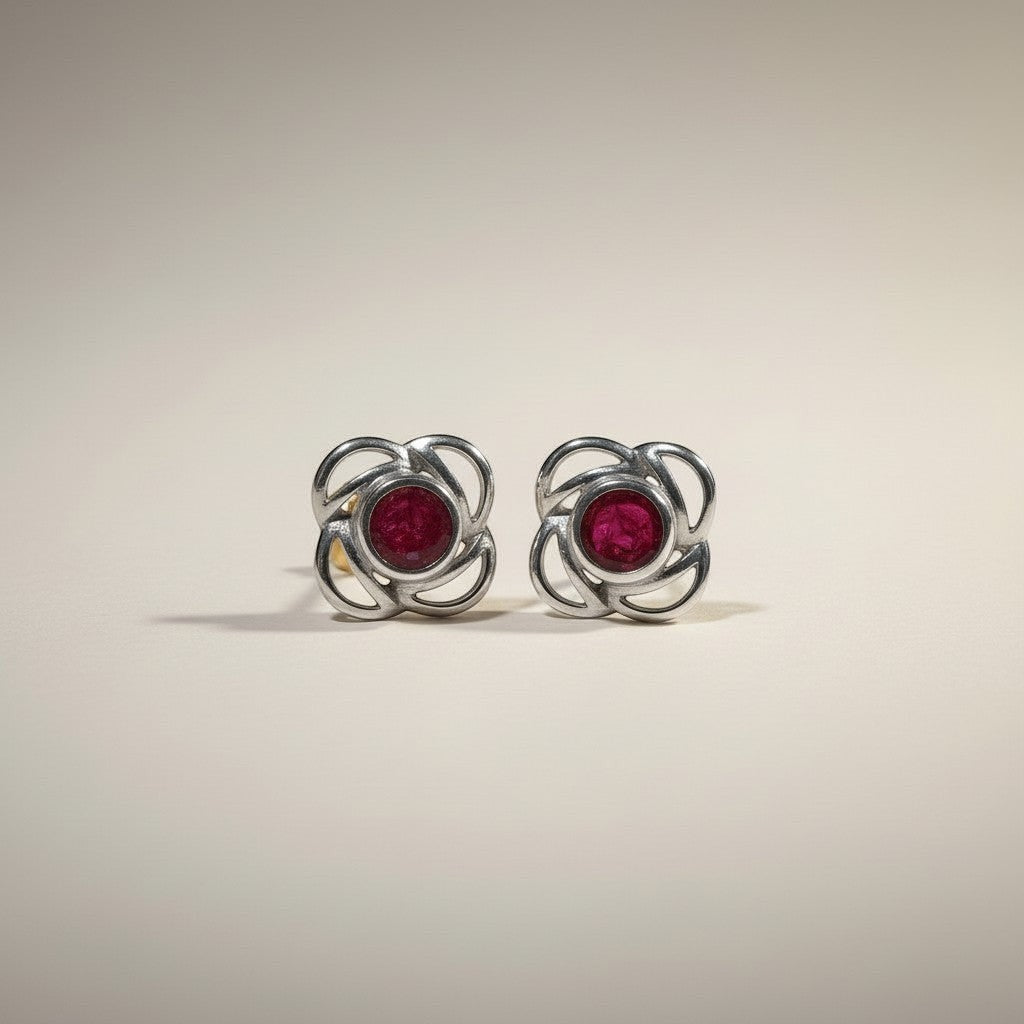 Ashes In Jewellery gold-tone stud earrings with deep red stone and swirling metalwork, screw-back closure.