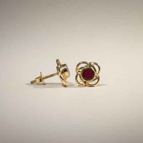 Ashes In Jewellery gold-tone stud earrings with swirling metalwork and a deep red stone. Flower design.