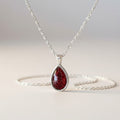 Ashes In Jewellery teardrop pendant necklace with green glitter stone in silver-tone bezel and delicate chain.