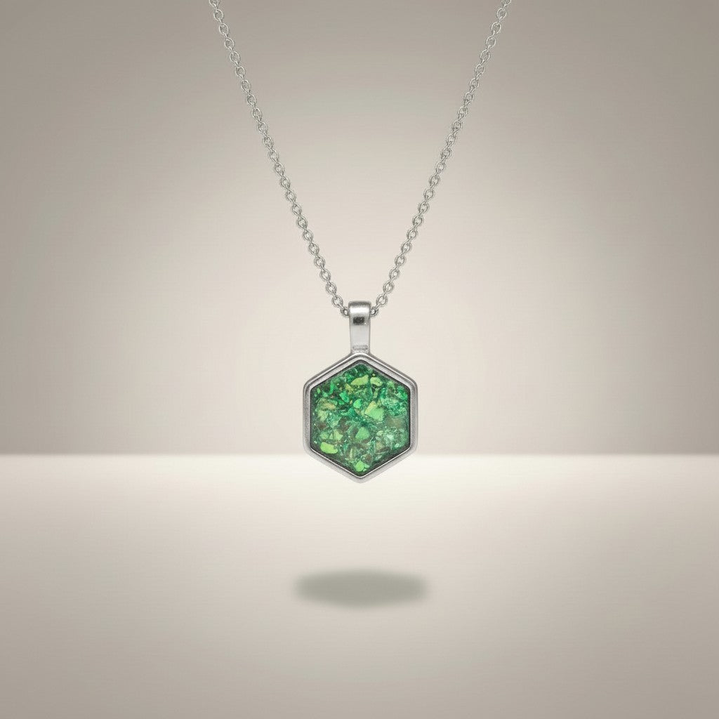 Ashes In Jewellery gold hexagon memorial pendant with green ashes inlay. Holds ashes.