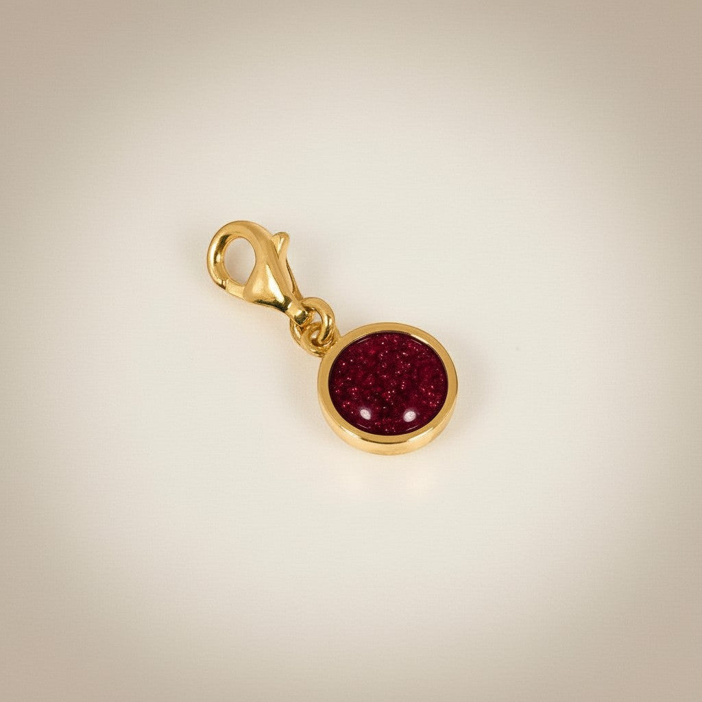 Ashes In Jewellery silver-tone round charm with red glitter cabochon and lobster clasp.
