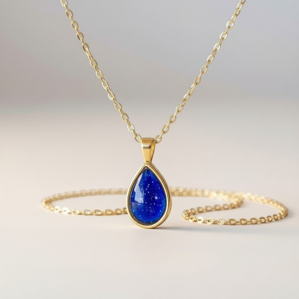 Ashes In Jewellery teardrop pendant necklace with a deep red glitter stone in a gold-tone bezel and delicate gold chain.