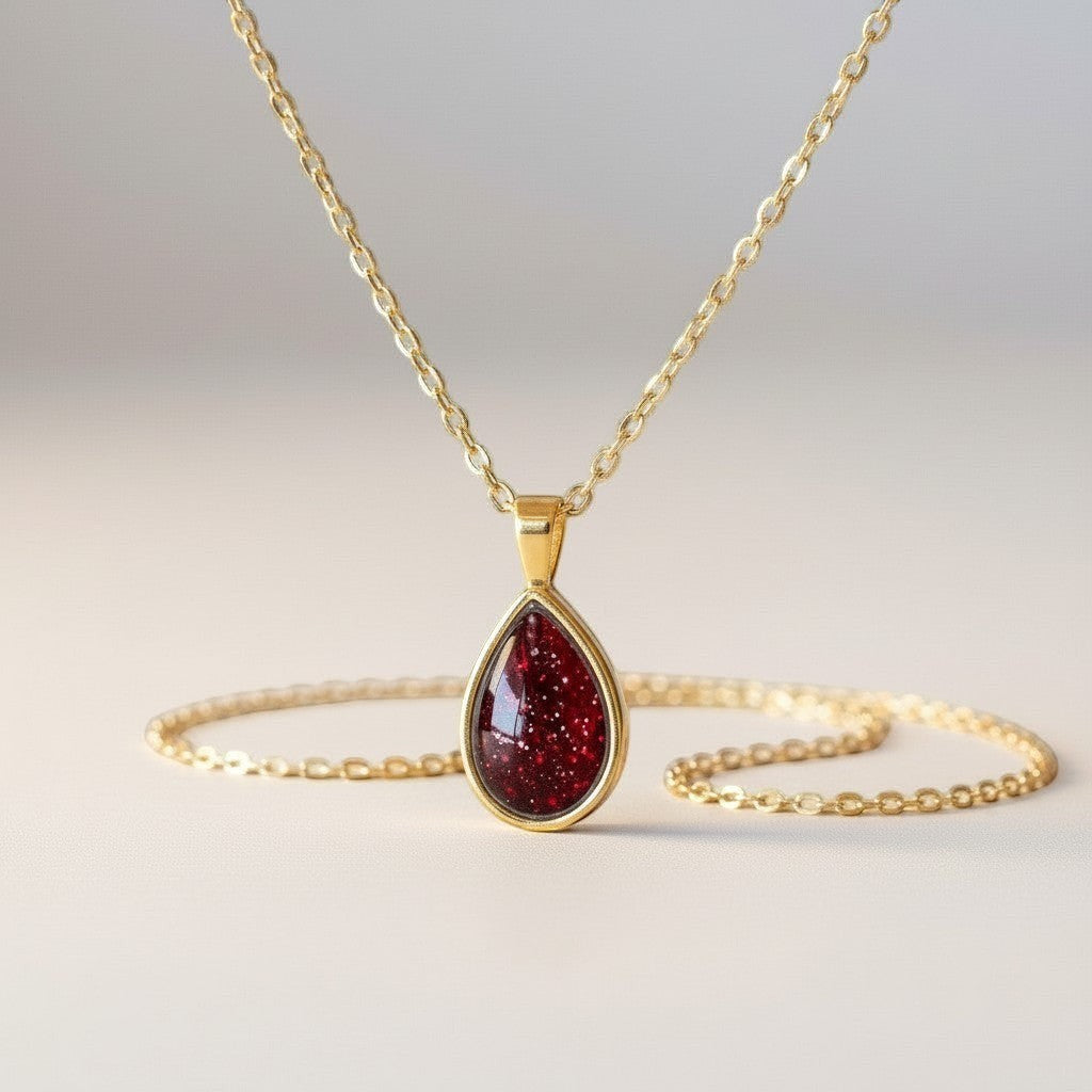 Ashes In Jewellery teardrop pendant necklace with a deep red, glitter-filled stone in a silver-tone bezel and delicate chain.