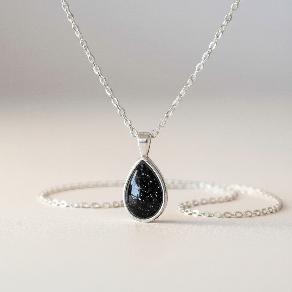 Ashes In Jewellery teardrop pendant necklace with a deep red glitter stone in a silver-tone bezel and delicate chain.