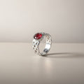 Ashes In Jewellery rose gold Celtic ring with red stone and intricate knotwork band.